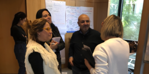 Team members discussing communication skills through face-to-face conversation during a workshop. 