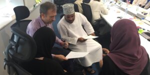 Diverse team members discussing workplace concerns while practising communication skills under pressure. 