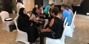 Diverse colleagues discussing ideas together during a workshop focused on the benefits of self-awareness. 