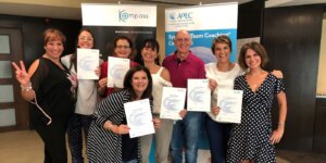 Graduates holding certificates after completing a programme to become an ICF coach.
