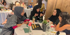 Group of coaches discussing ideas during an ICF coach training workshop.