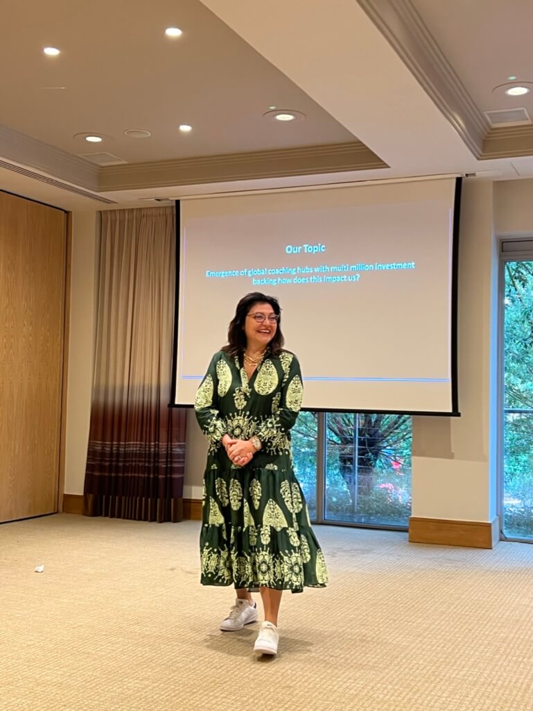 A speaker presenting on how leaders inspire action by connecting purpose with leadership, based on Simon Sinek’s lessons.