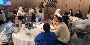 Diverse group collaborating during a workshop on transformational leadership. 