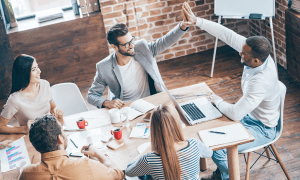 Kompass Consultancy professionals join hands in a unified display of teamwork and collaboration.