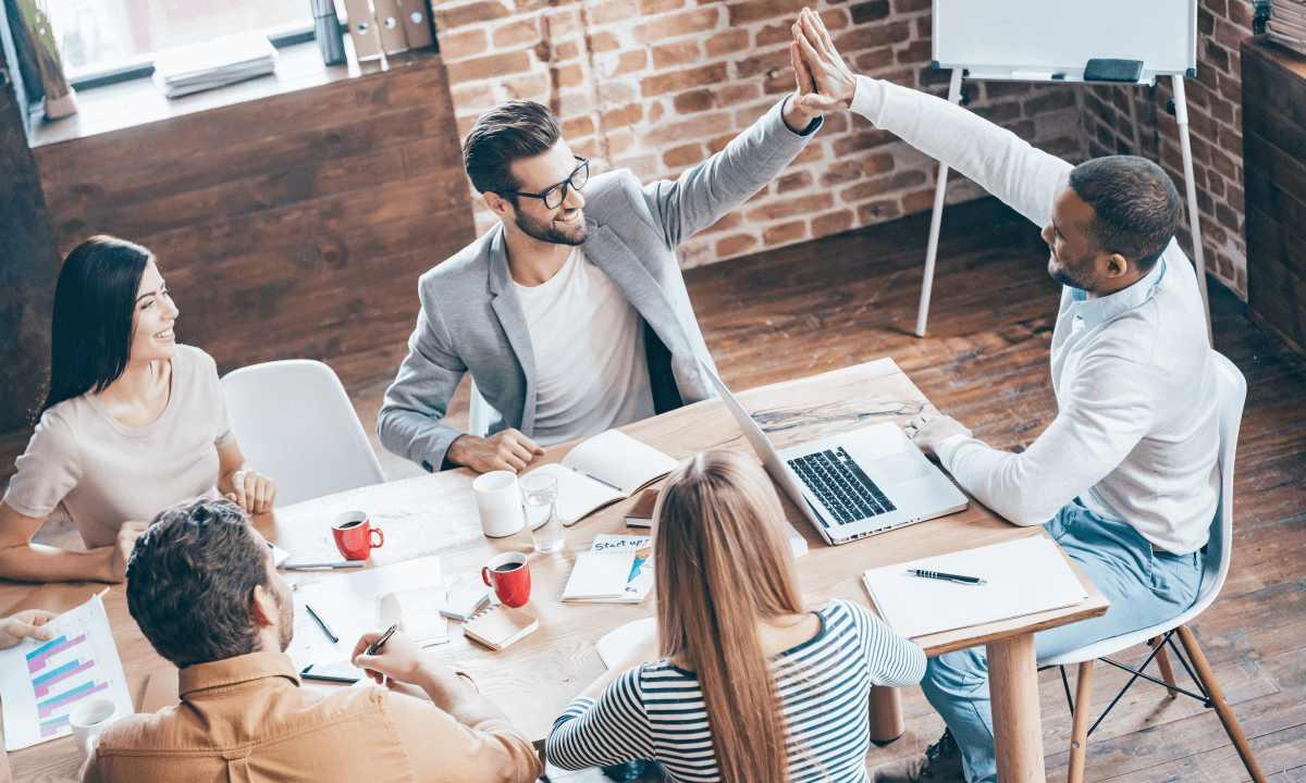 Kompass Consultancy professionals join hands in a unified display of teamwork and collaboration.