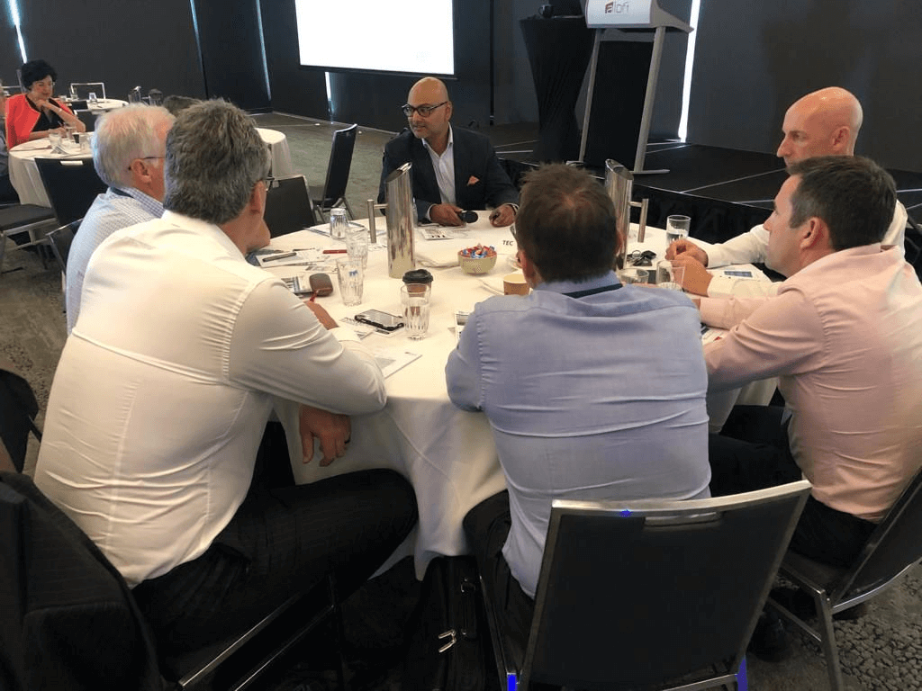 Coach Gaj Ravichandra leads a people management session, demonstrating effective team collaboration in a professional setting. 