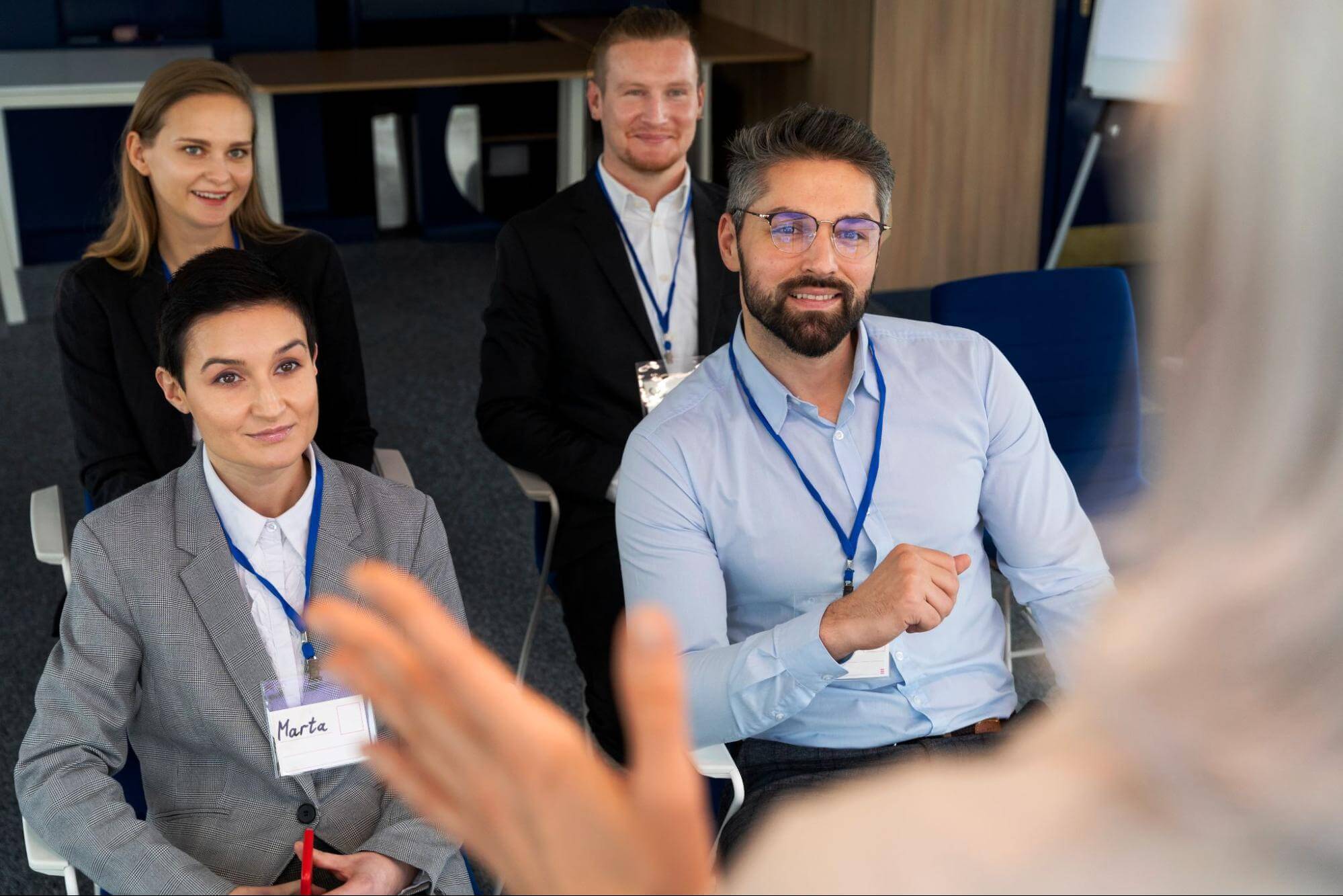 A group of professionals listening attentively to a business presentation, showing respect for teamwork and work ethic