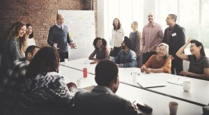 A professional coach from Kompass Consultancy guides his team through a strategy session, fostering growth and collaboration.