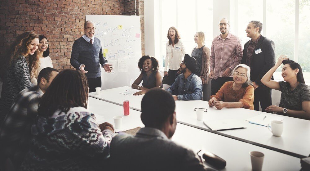 A professional coach from Kompass Consultancy guides his team through a strategy session, fostering growth and collaboration.