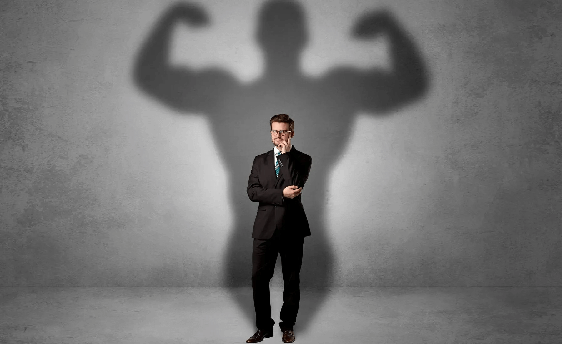 A man with an inflated ego casts a strong, exaggerated shadow.