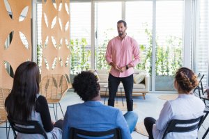 Man presenting group session on skills required for coaching