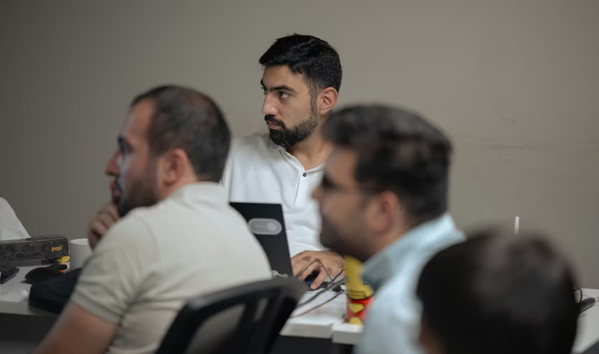 Teammates listening to a leader’s discussion. 