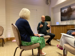 A leader and two women seated, engaged in a discussion about career growth within their organization