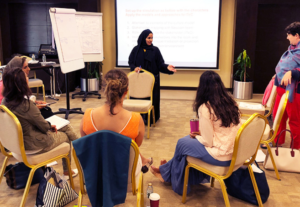Participants sitting in chairs, involved in an interactive session on executive coaching for career growth.