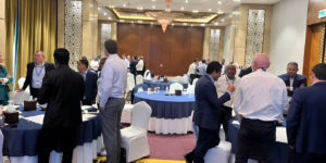 Professionals engaging in negotiation and networking discussions during a collaborative business communication event 