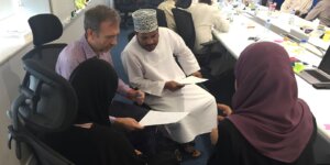 Professionals discussing constructive feedback during a one-to-one workplace coaching session. 