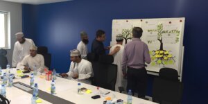Team members collaborating during a workplace workshop on constructive feedback, communication, and team performance. 